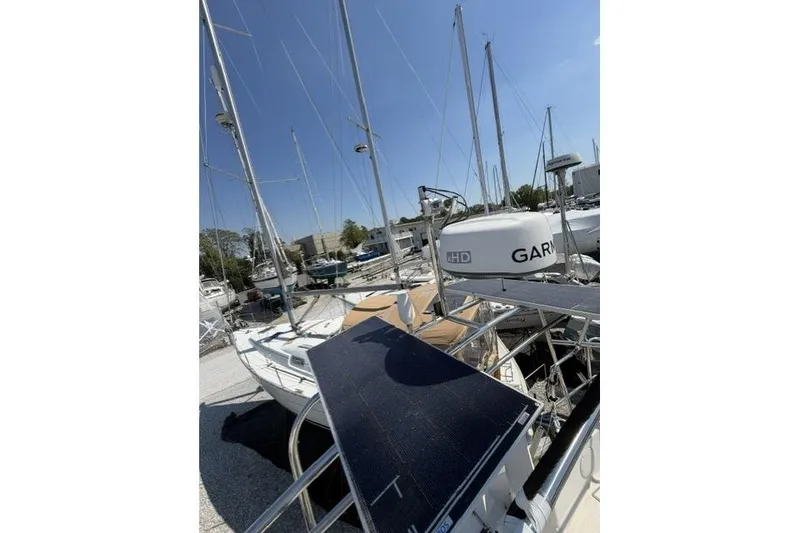 Slide: The Image of Sailboat Saga 43, 2002 model, docked with solar panel and Garmin equipment. - 14