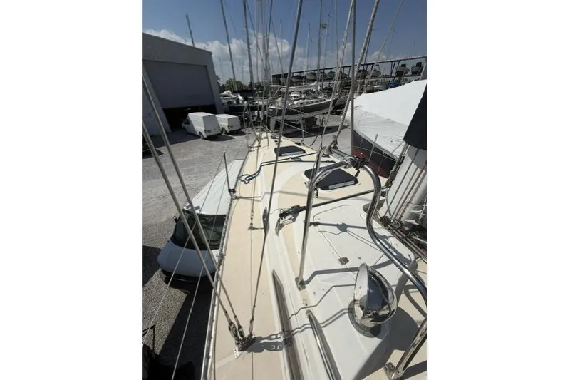 Slide: The Image of Deck view of 2002 Saga 43 sailboat in a marina, showcasing rigging and equipment. - 17