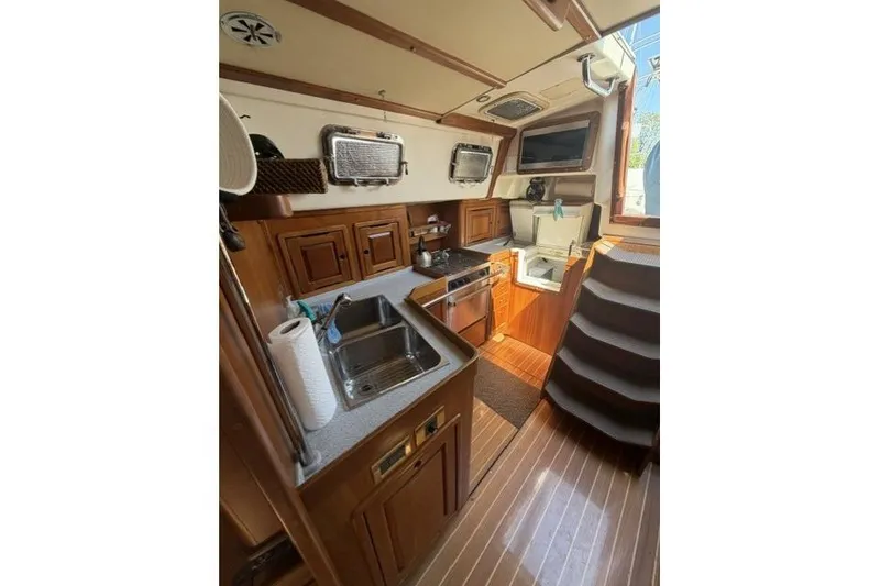 Slide: The Image of Interior of 2002 Saga 43 yacht featuring a compact, well-equipped kitchen area. - 19