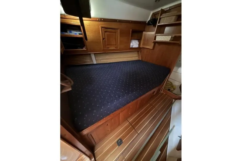 Slide: The Image of Cozy cabin interior of 2002 Saga 43 yacht with wooden furnishings and a comfortable bed. - 23