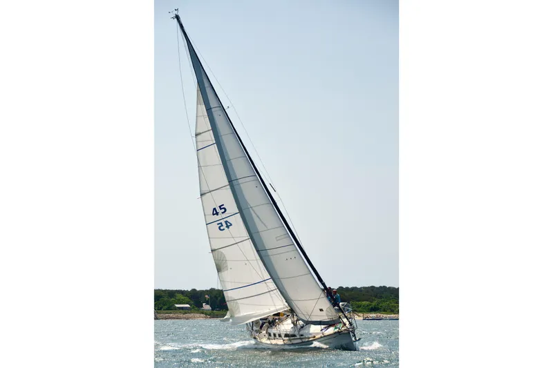 Slide: The Image of Sailing yacht Saga 43 from 2002 gliding on open water under clear skies. - 4