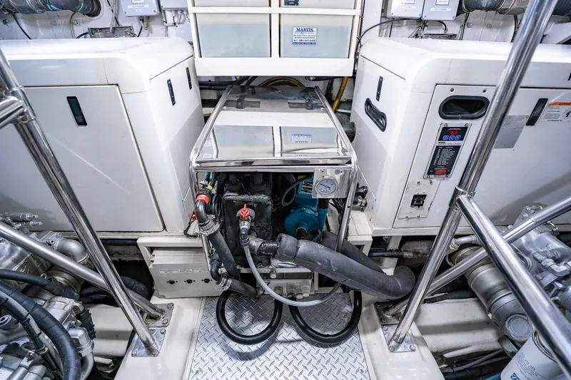 Slide: The Image of Engine room of a 2010 Pershing 80 yacht, showcasing machinery and equipment. - 103