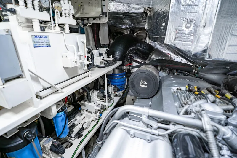 Slide: The Image of Engine room of a 2010 Pershing 80 yacht, showcasing mechanical components and systems. - 107