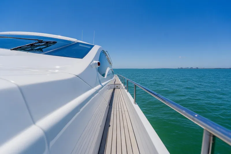 Slide: The Image of Sleek 2010 Pershing 80 yacht cruising on clear blue ocean under sunny skies. - 114