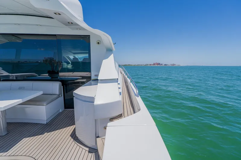 Slide: The Image of Luxurious 2010 Pershing 80 yacht cruising on clear blue waters under a sunny sky. - 116