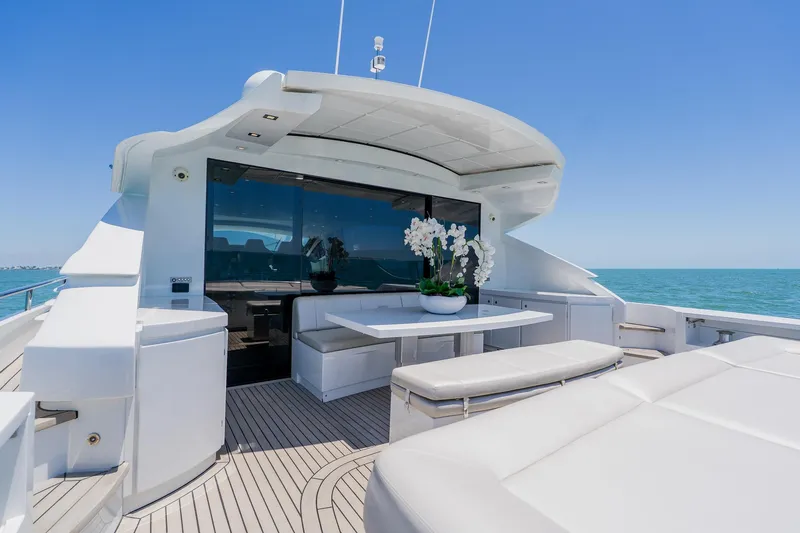 Slide: The Image of Luxurious 2010 Pershing 80 yacht deck with seating, ocean view, and elegant decor. - 117