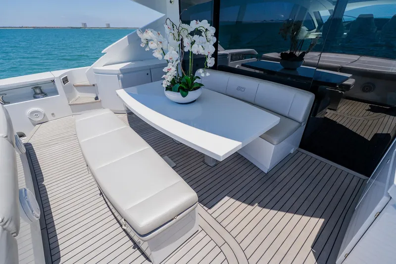 Slide: The Image of Luxurious 2010 Pershing 80 yacht deck with elegant seating and floral centerpiece. - 120