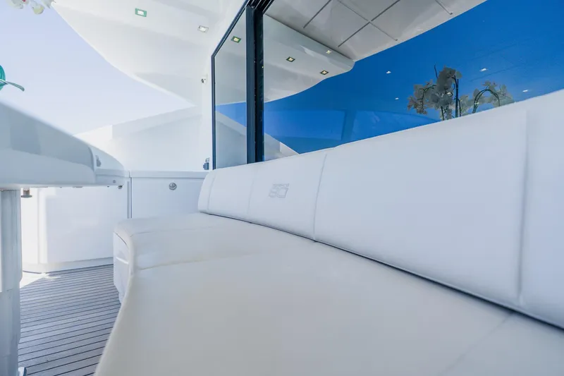 Slide: The Image of Luxurious seating area on a 2010 Pershing 80 yacht with sleek white upholstery. - 121
