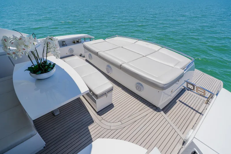 Slide: The Image of Luxurious 2010 Pershing 80 yacht deck with seating, table, and ocean view. - 122