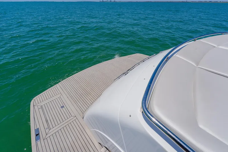 Slide: The Image of Luxury Pershing 80 yacht deck overlooking serene blue ocean waters, 2010 model. - 125