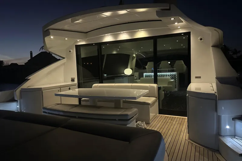 Slide: The Image of Luxurious 2010 Pershing 80 yacht interior with elegant seating and ambient lighting at dusk. - 126