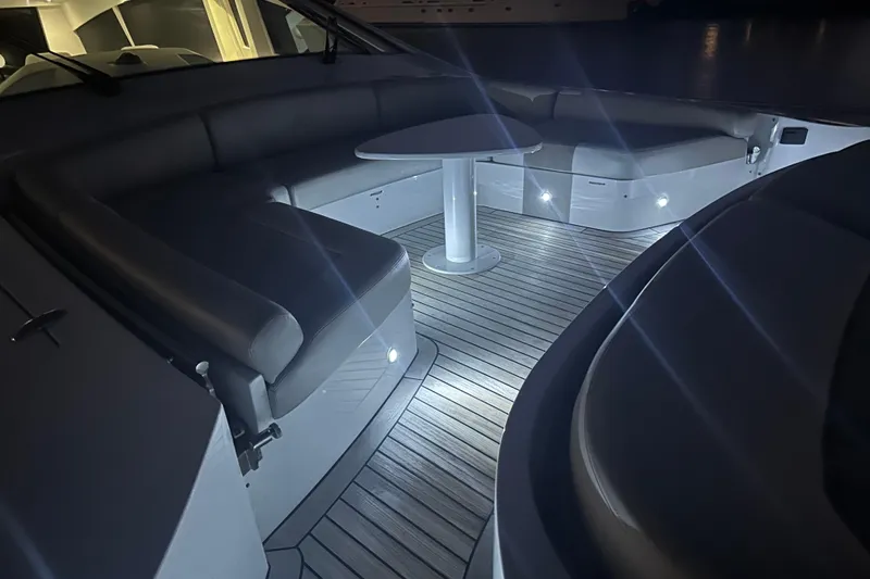 Slide: The Image of Luxurious seating area on a 2010 Pershing 80 yacht, featuring ambient lighting. - 127