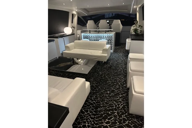 Slide: The Image of Luxurious interior of a 2010 Pershing 80 yacht with modern white seating and stylish decor. - 129