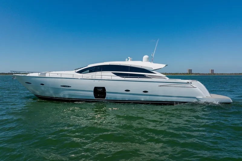 Slide: The Image of Luxury 2010 Pershing 80 yacht cruising on open water under clear blue sky. - 14