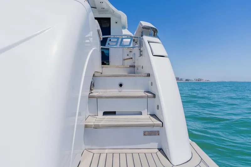 Slide: The Image of Staircase on 2010 Pershing 80 yacht with ocean view and clear blue sky. - 16