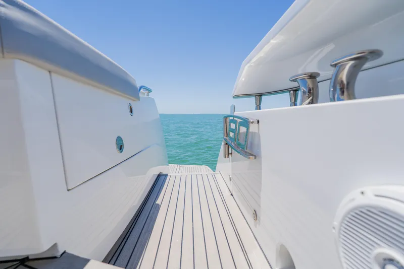 Slide: The Image of Luxury Pershing 80 yacht deck, 2010 model, overlooking serene ocean waters. - 17