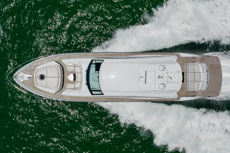 Slide: The Image of Top view of a 2010 Pershing 80 yacht cruising on green water. - 2
