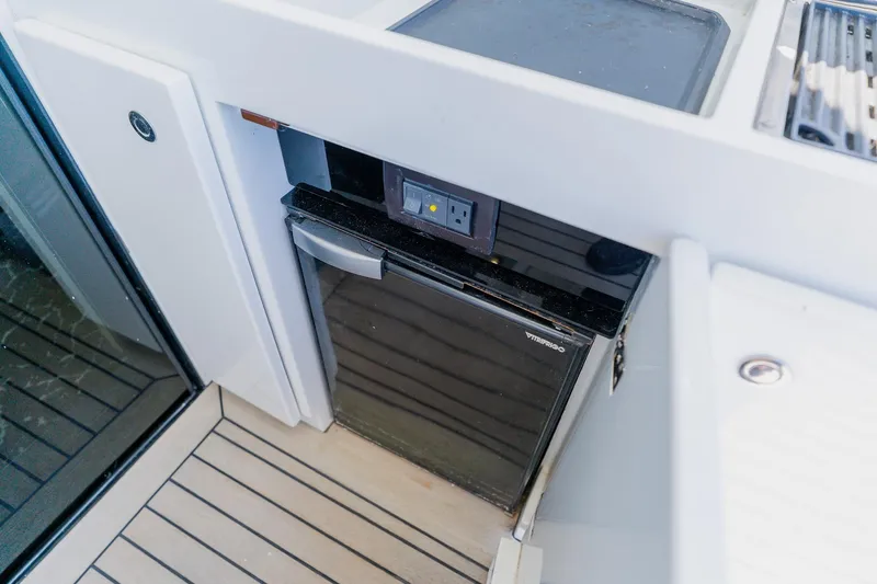 Slide: The Image of Compact fridge on 2010 Pershing 80 yacht deck, featuring sleek design and modern amenities. - 21