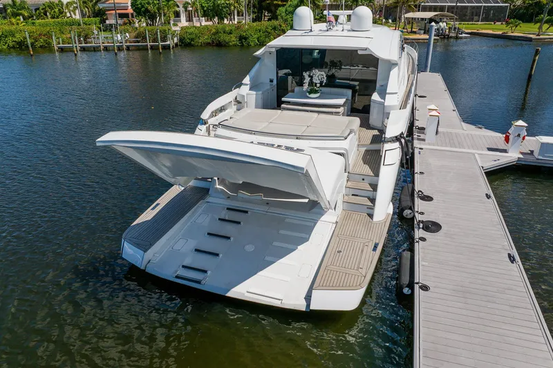 Slide: The Image of Luxury 2010 Pershing 80 yacht docked, featuring spacious deck and sleek design. - 22