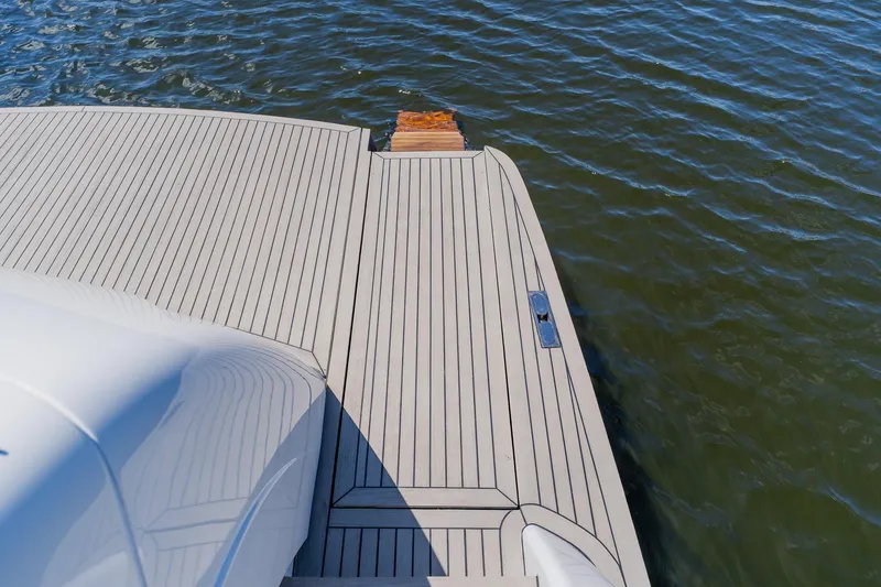 Slide: The Image of Luxury Pershing 80 yacht deck, 2010 model, overlooking calm water. - 25
