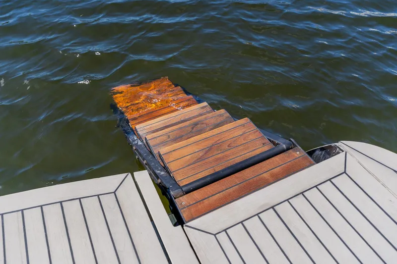 Slide: The Image of Wooden swim platform on 2010 Pershing 80 yacht, partially submerged in water. - 26