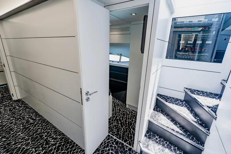 Slide: The Image of Interior of 2010 Pershing 80 yacht with modern design and sleek staircase. - 28