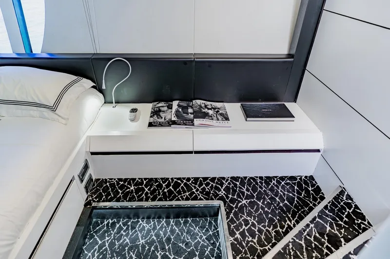 Slide: The Image of Luxurious interior of 2010 Pershing 80 yacht with modern bedside table and elegant decor. - 30