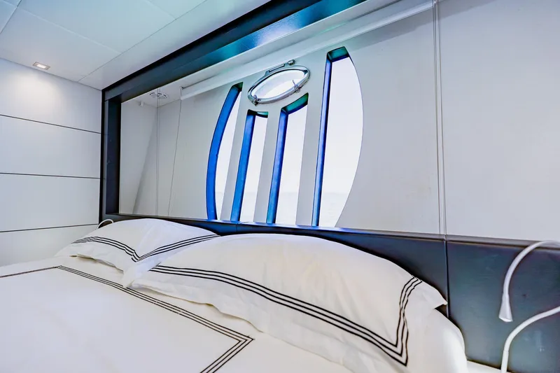Slide: The Image of Luxurious bedroom interior on a 2010 Pershing 80 yacht, featuring elegant bedding and modern design. - 34