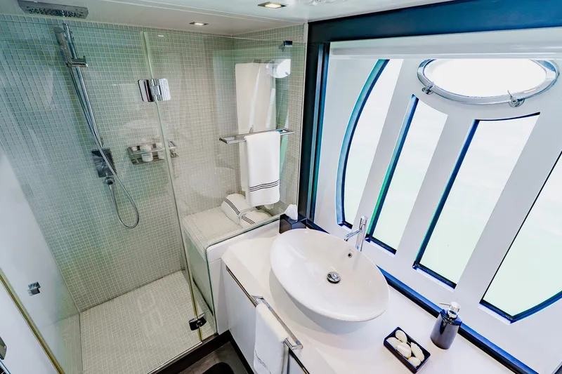 Slide: The Image of Luxurious bathroom on a 2010 Pershing 80 yacht with modern shower and elegant sink. - 38