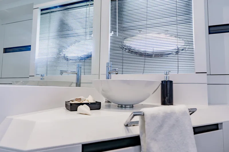 Slide: The Image of Luxurious bathroom interior on a 2010 Pershing 80 yacht, featuring modern sink and sleek design. - 46