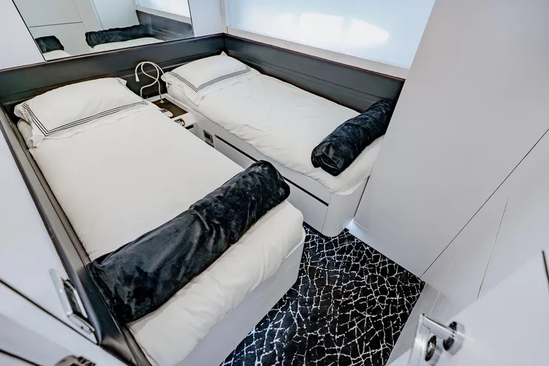 Slide: The Image of Luxurious twin cabin interior on a 2010 Pershing 80 yacht, featuring modern bedding and decor. - 49
