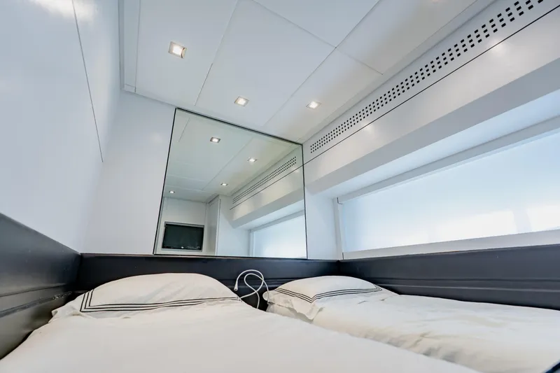Slide: The Image of Luxurious twin cabin interior on a 2010 Pershing 80 yacht, featuring modern design elements. - 51