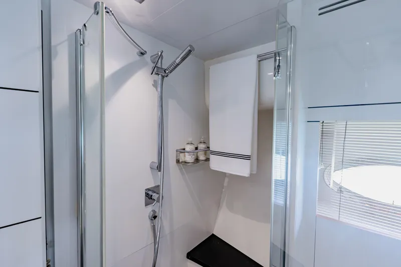 Slide: The Image of Luxurious shower area in 2010 Pershing 80 yacht with modern fixtures and window. - 54
