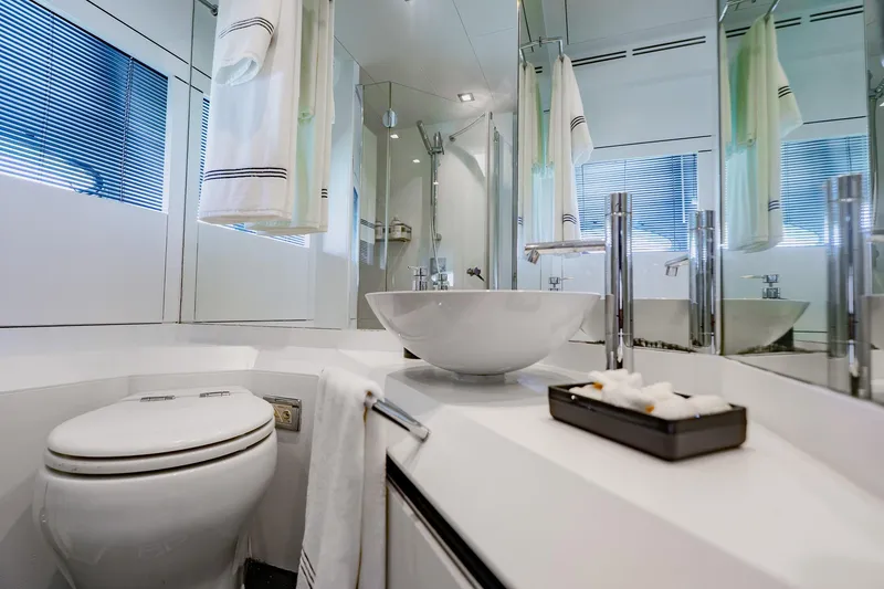 Slide: The Image of Luxurious bathroom on a 2010 Pershing 80 yacht, featuring modern fixtures and elegant design. - 56