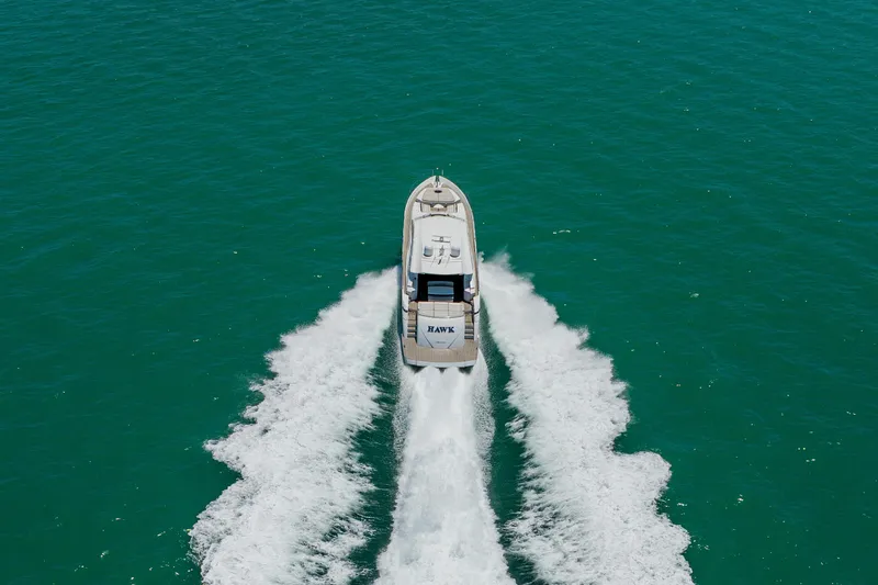 Slide: The Image of Aerial view of 2010 Pershing 80 yacht cruising on turquoise water. - 6