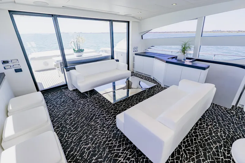 Slide: The Image of Luxurious interior of 2010 Pershing 80 yacht with modern white seating and ocean view. - 60