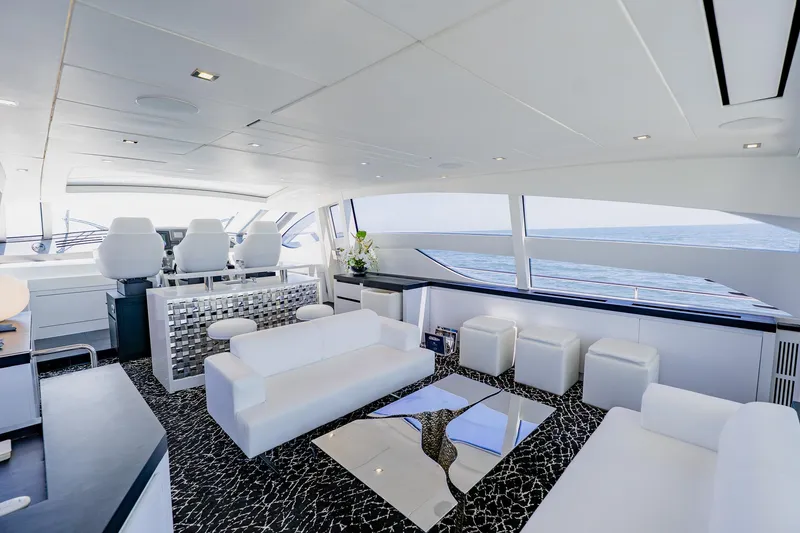 Slide: The Image of Luxurious interior of a 2010 Pershing 80 yacht with modern white seating and ocean view. - 63