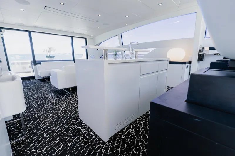 Slide: The Image of Luxurious interior of 2010 Pershing 80 yacht with modern white furnishings and panoramic windows. - 66