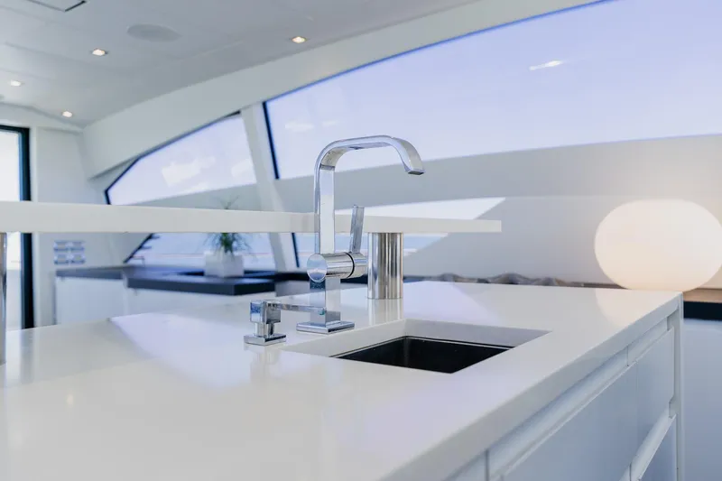 Slide: The Image of Modern kitchen sink on 2010 Pershing 80 yacht, featuring sleek design and elegant fixtures. - 67