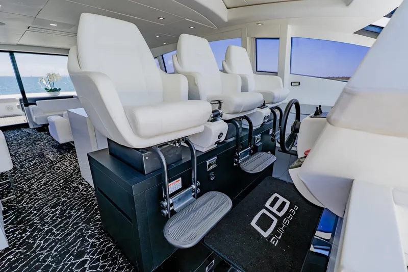 Slide: The Image of Luxurious interior of a 2010 Pershing 80 yacht with modern seating and steering. - 70