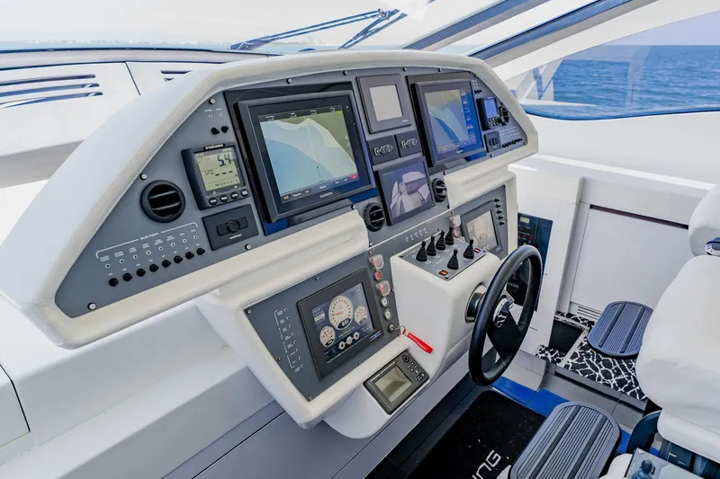 Slide: The Image of Cockpit of 2010 Pershing 80 yacht with advanced navigation systems and controls. - 73