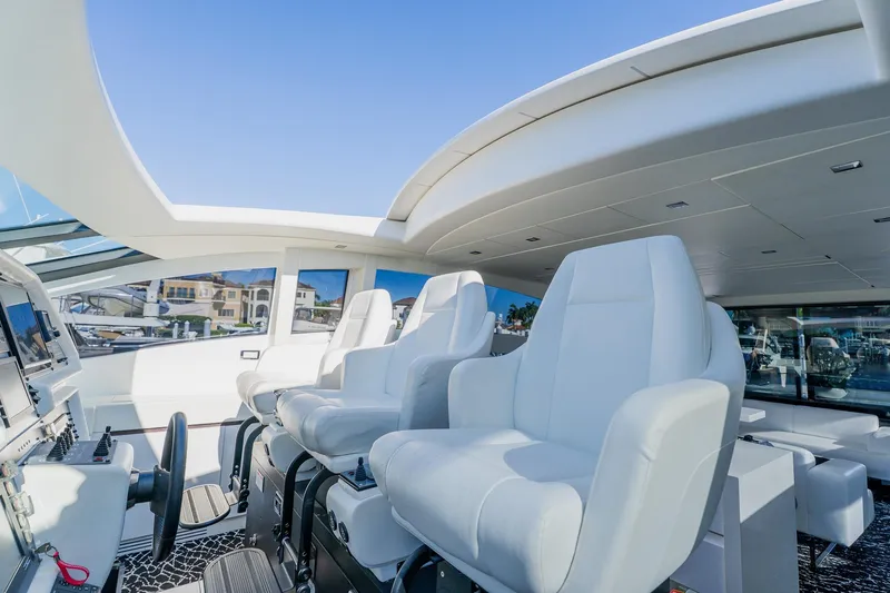 Slide: The Image of Luxurious interior of 2010 Pershing 80 yacht with plush white seating and modern controls. - 77