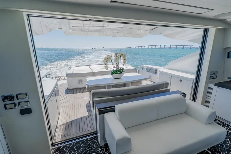 Slide: The Image of Luxurious 2010 Pershing 80 yacht interior with ocean view and elegant seating area. - 80