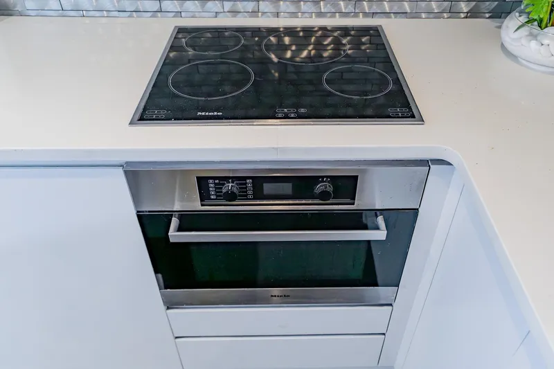 Slide: The Image of Modern kitchen with Miele cooktop and oven on Pershing 80 yacht, 2010 model. - 85