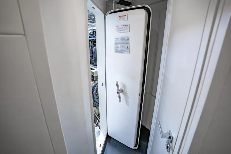 Slide: The Image of Engine room door on a 2010 Pershing 80 yacht, partially open. - 92