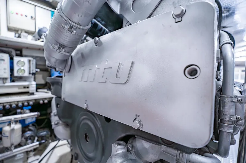 Slide: The Image of Engine room of a 2010 Pershing 80 yacht, showcasing mechanical components. - 98