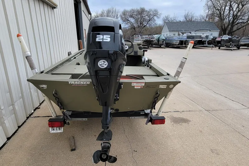 Slide: The Image of 2017 Tracker Grizzly 1648 SC boat with 25 HP motor in a parking lot. - 10