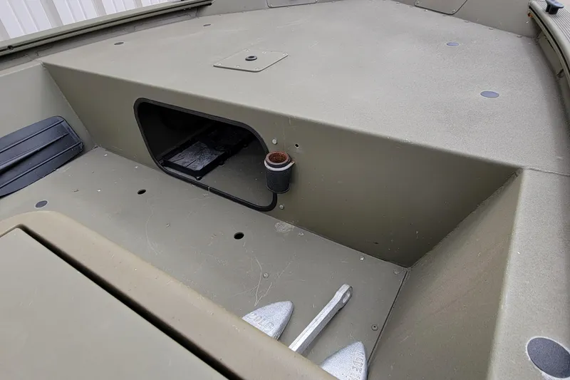 Slide: The Image of 2017 Tracker Grizzly 1648 SC boat interior with storage compartment and anchor. - 11
