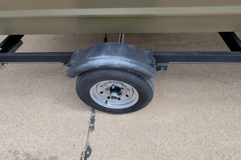 Slide: The Image of Trailer wheel of 2017 Tracker Grizzly 1648 SC on concrete surface. - 15