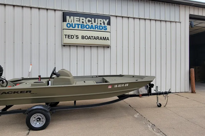 Slide: The Image of 2017 Tracker Grizzly 1648 SC boat at Ted's Boatarama, Mercury Outboards sign visible. - 17